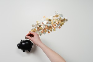 Picture which represents putting money into a piggy bank