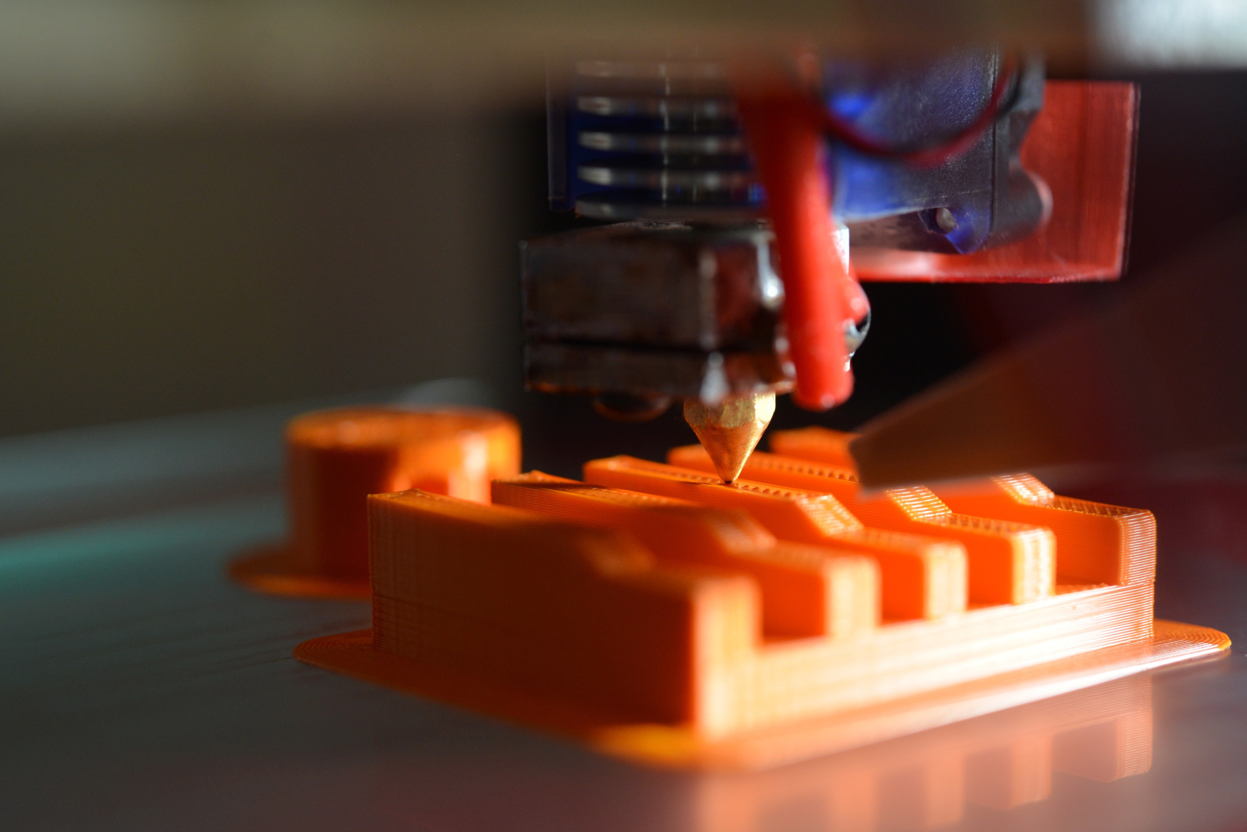 Plastic 3d printer fusing plastic to create an object.