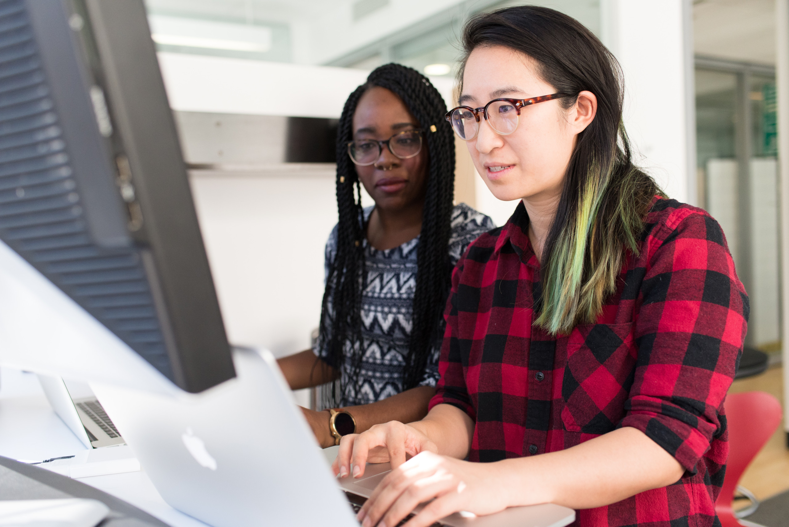 Two people looking at the laptop